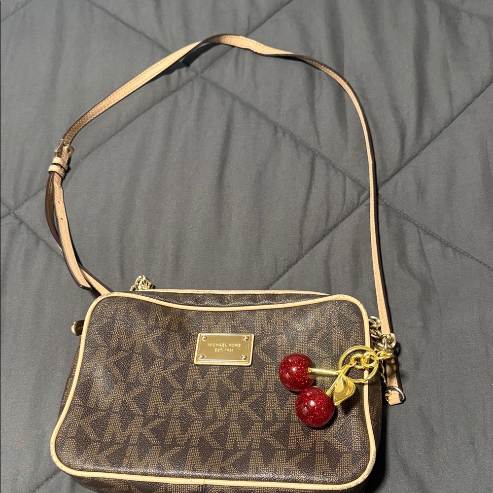 Michael Kors Tan and Brown Monogram Crossbody Bag does not include cherries